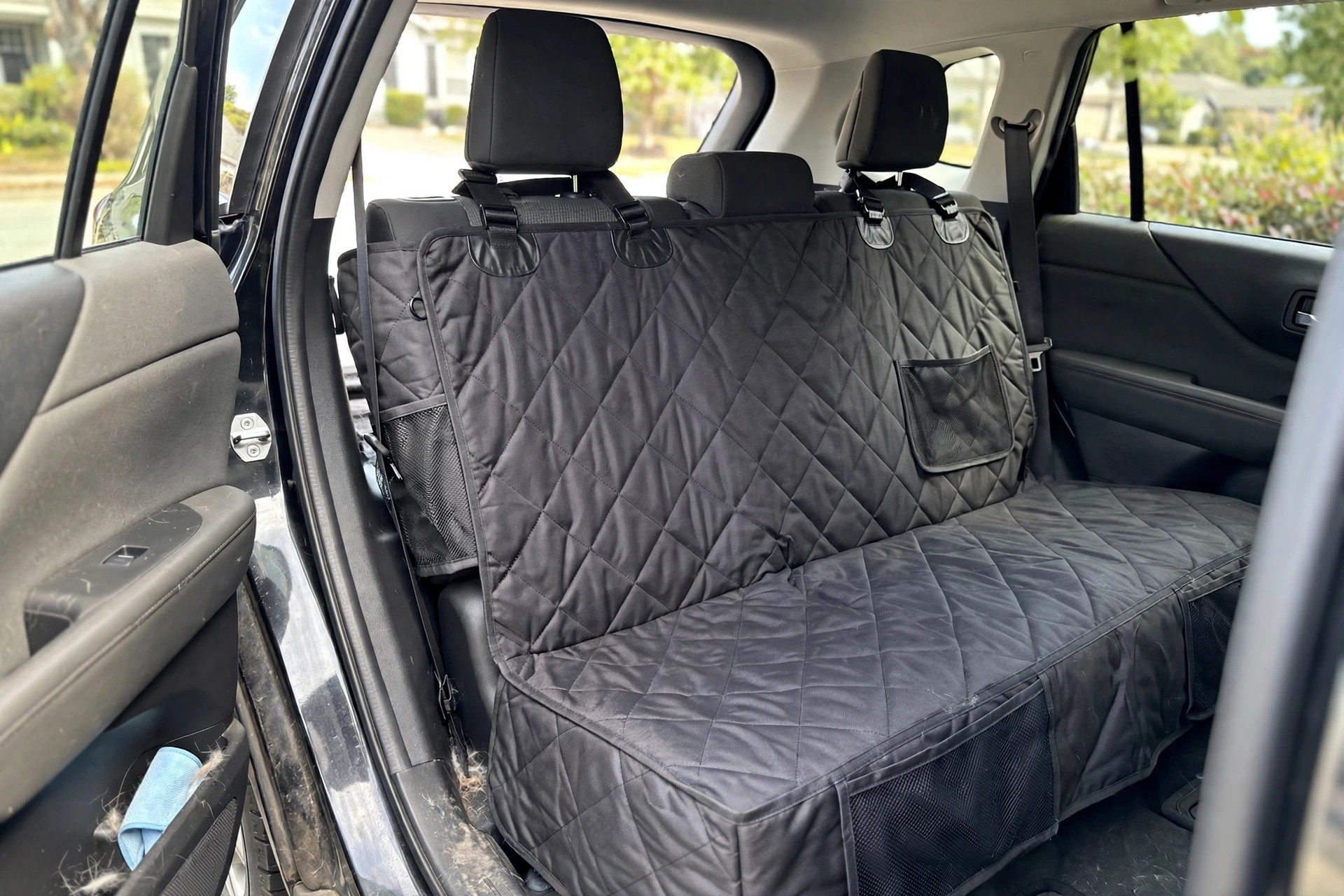 dog car seat cover for back seat protection: Dog car seat cover installed over a back seat in a car