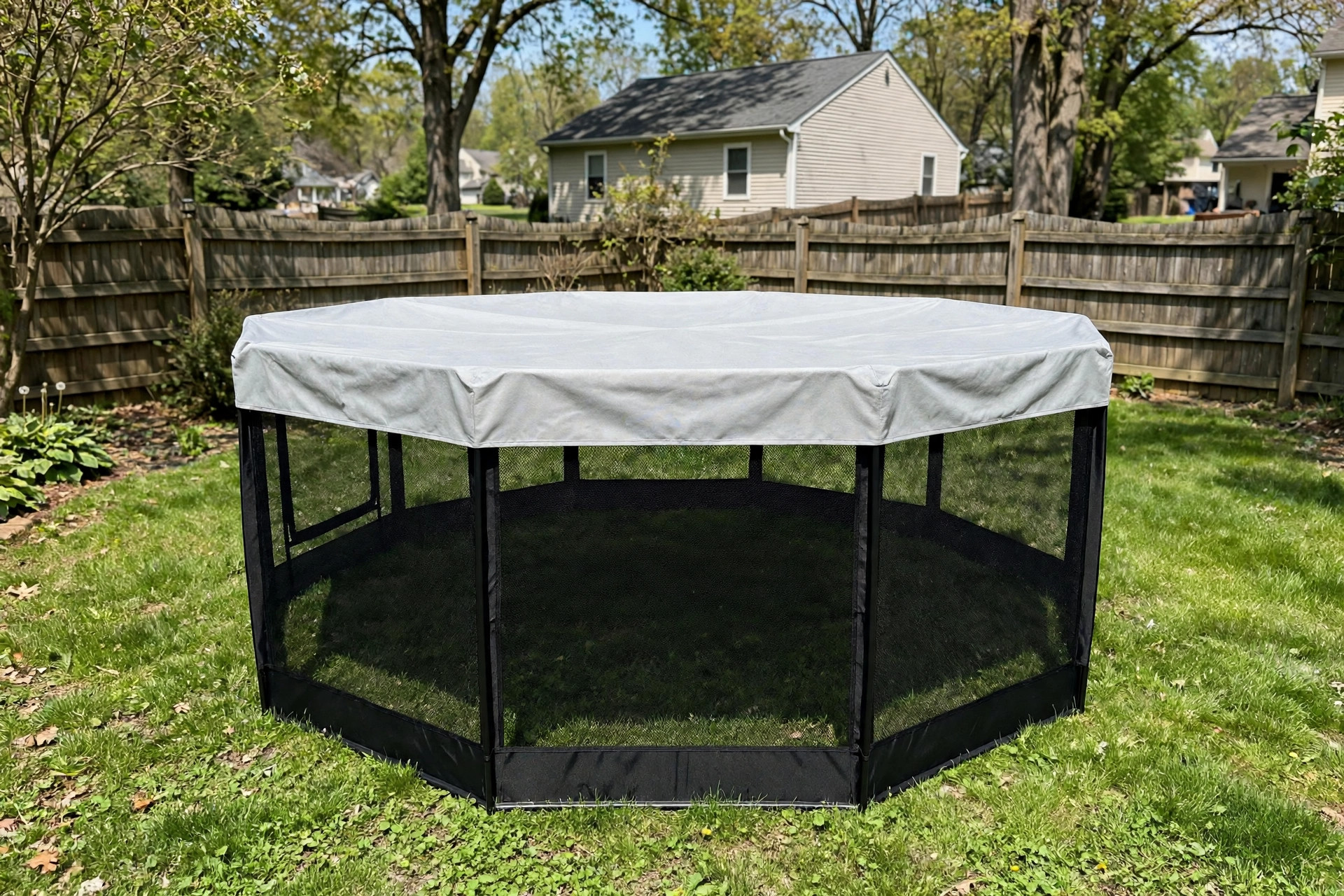 A pet playpen with cover for outdoor shade set up on a green lawn in an American backyard