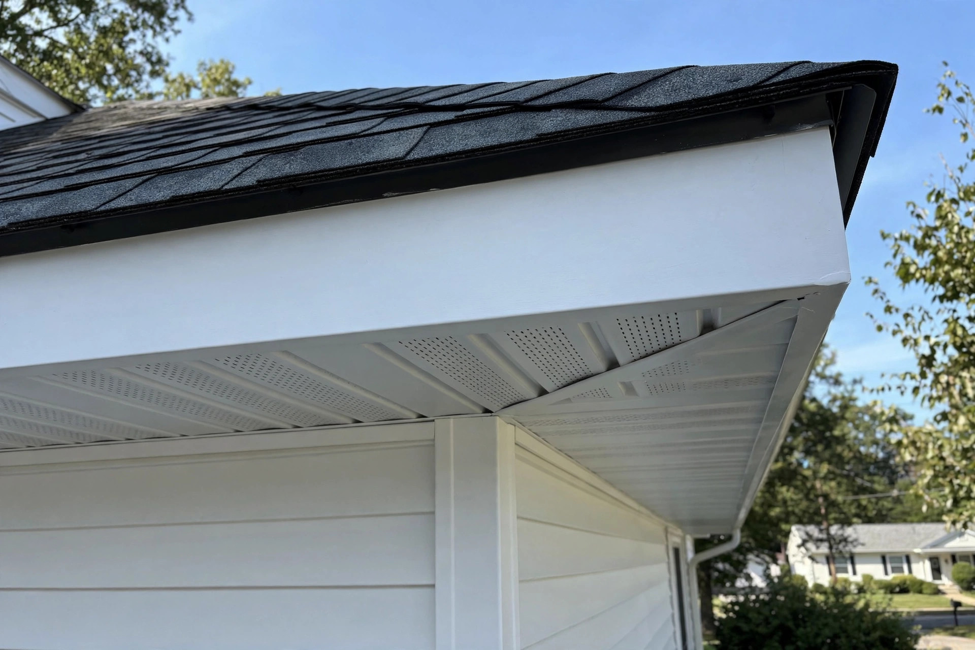 durable soffit and fascia repair near me: Repaired white soffit and fascia under a roof eave