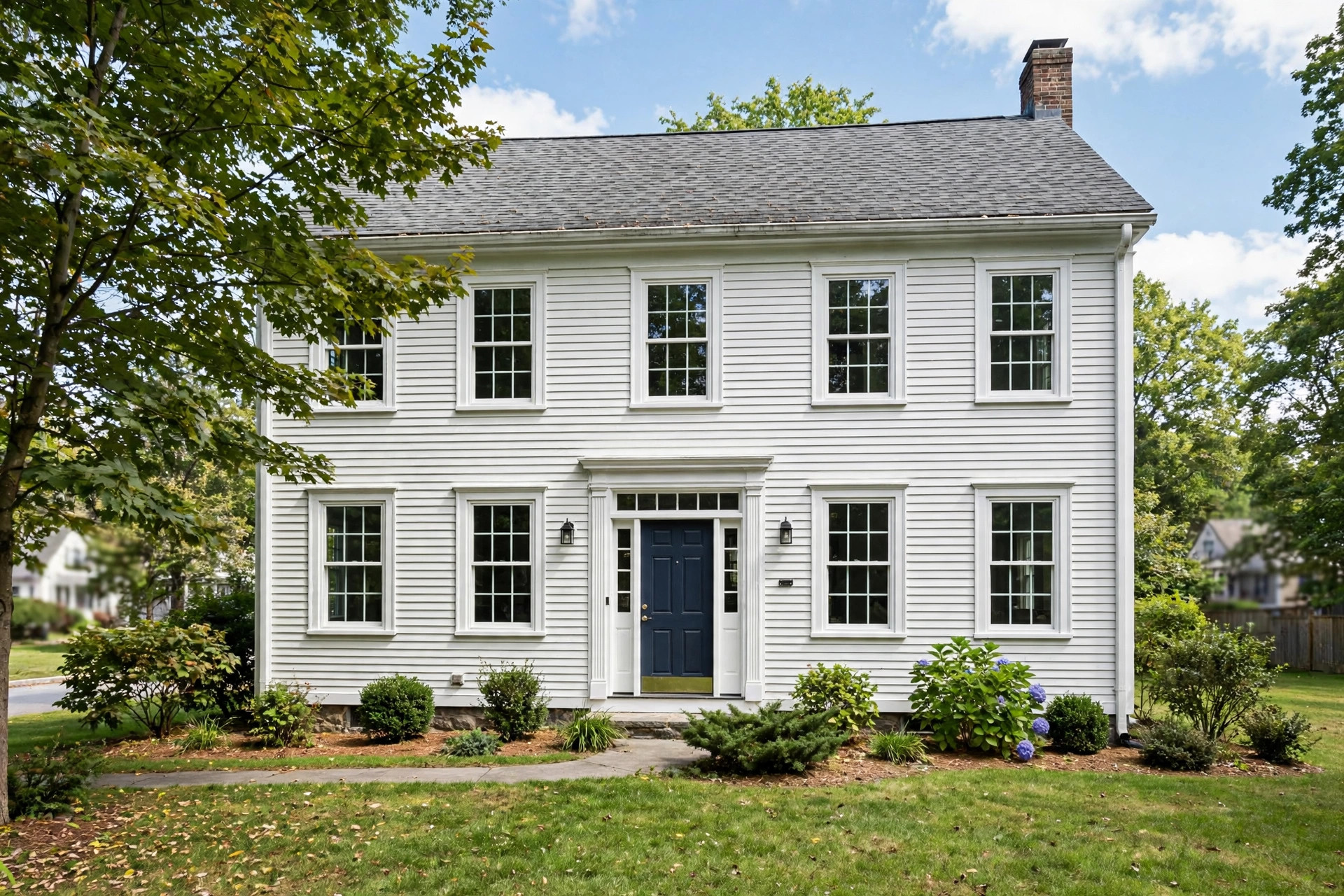 best vinyl replacement windows for new england homes: New vinyl replacement windows on a New England colonial home exterior