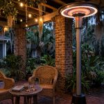 top rated electric patio heaters for southern states: A freestanding electric patio heater glowing warmly on a covered brick patio at a southern home
