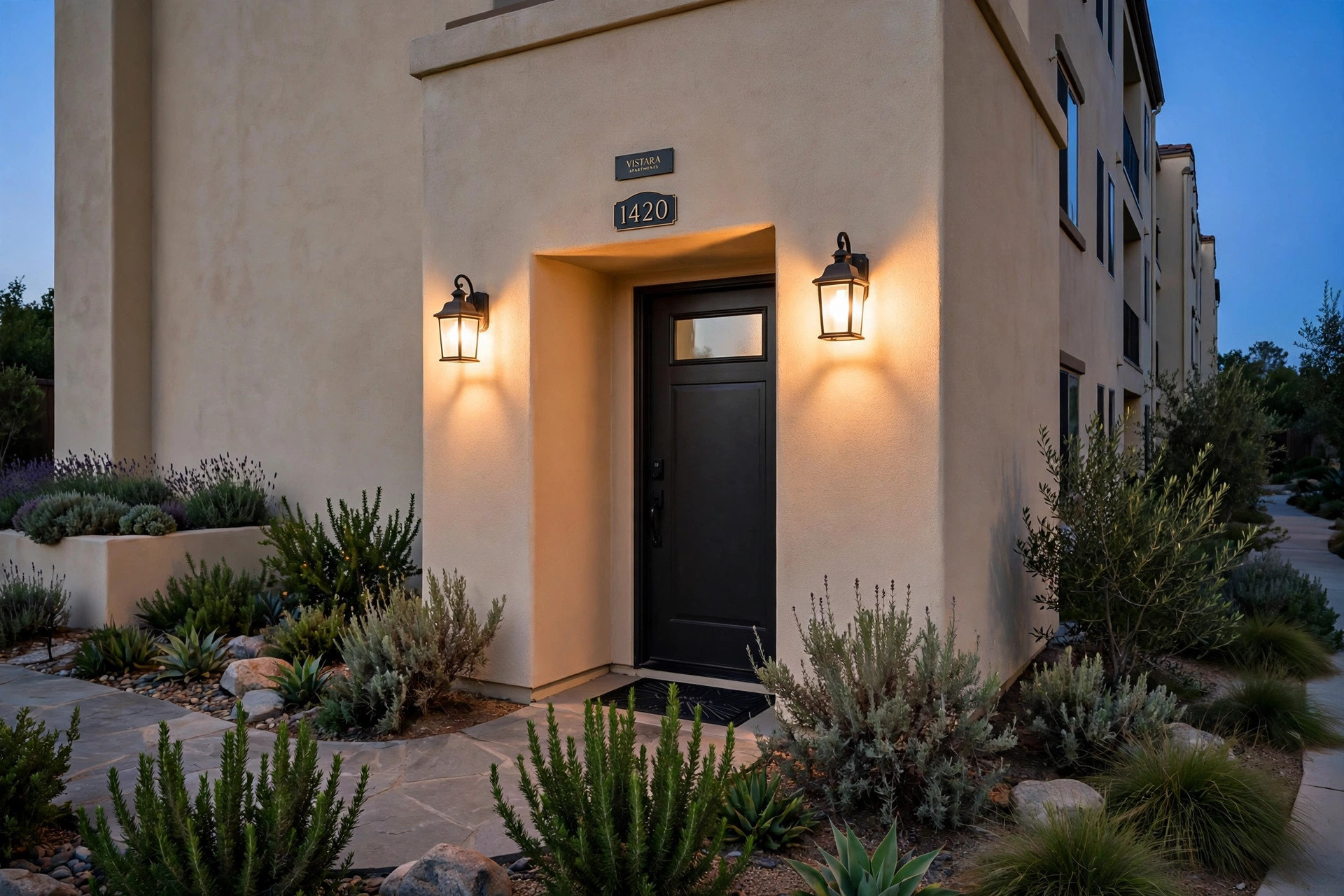 professional grade exterior lighting fixtures for california apartments: Professional grade exterior lighting fixtures mounted beside an apartment building entrance at dusk