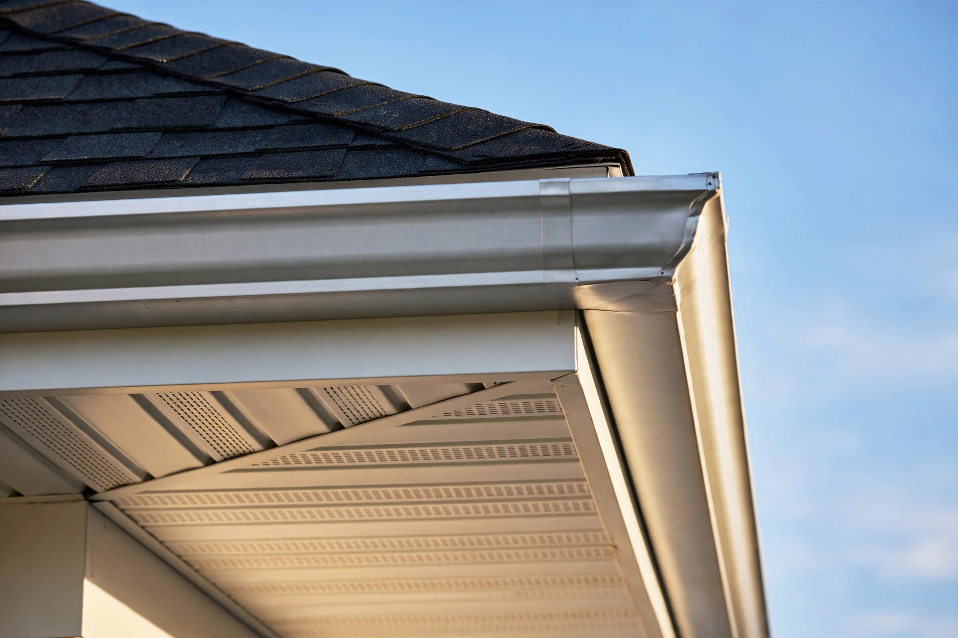 weather resistant soffit and fascia repair for homeowners: Repaired weather resistant soffit and fascia under a home roof edge