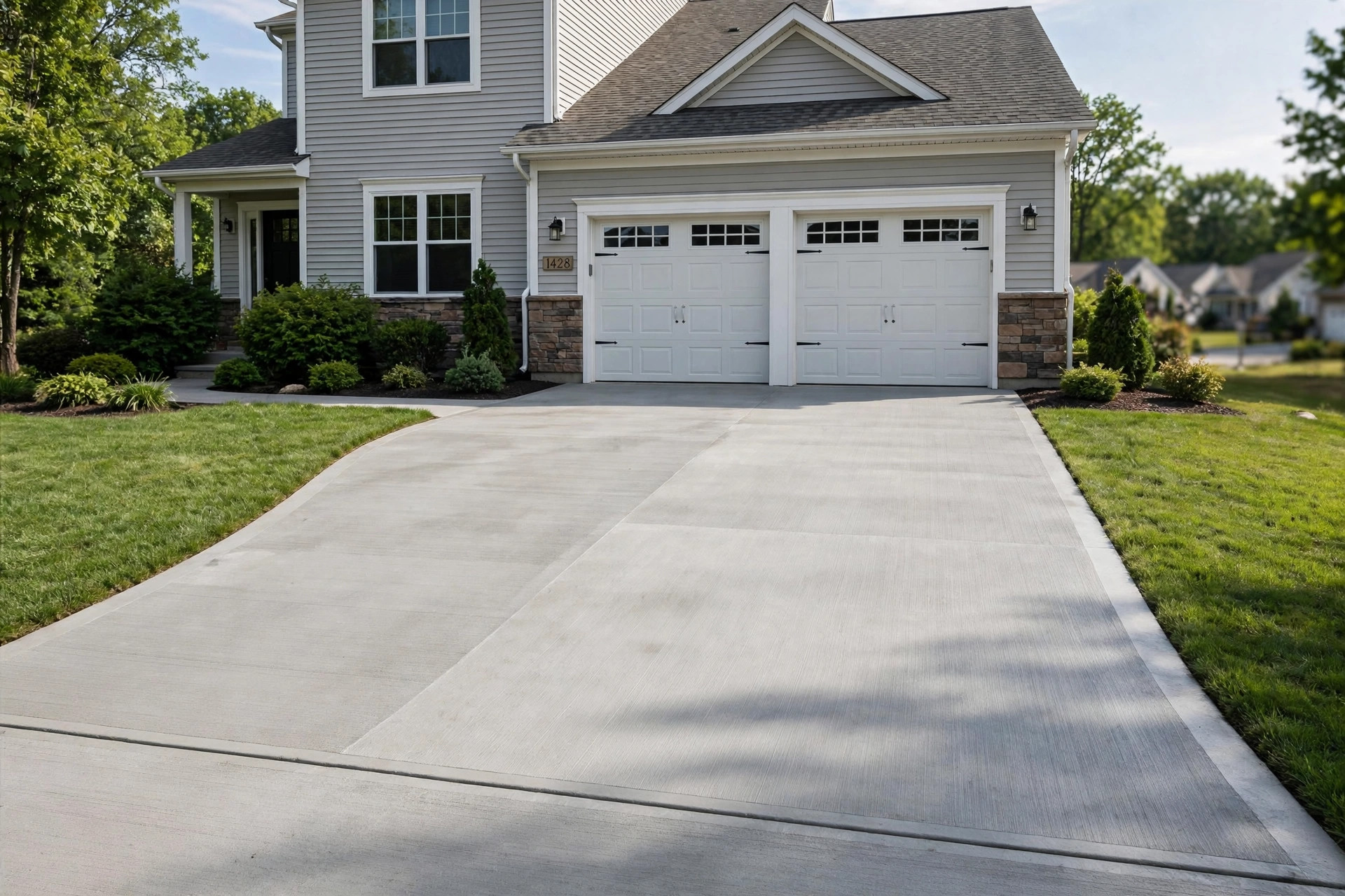 Best concrete driveway resurfacing near me: freshly resurfaced driveway at a suburban American home