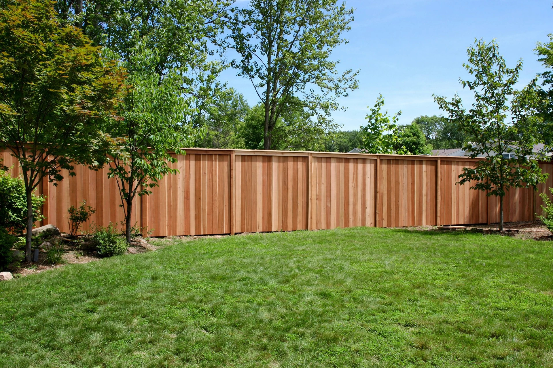 best fence installation contractors near me: A newly installed wooden privacy fence in a suburban American backyard
