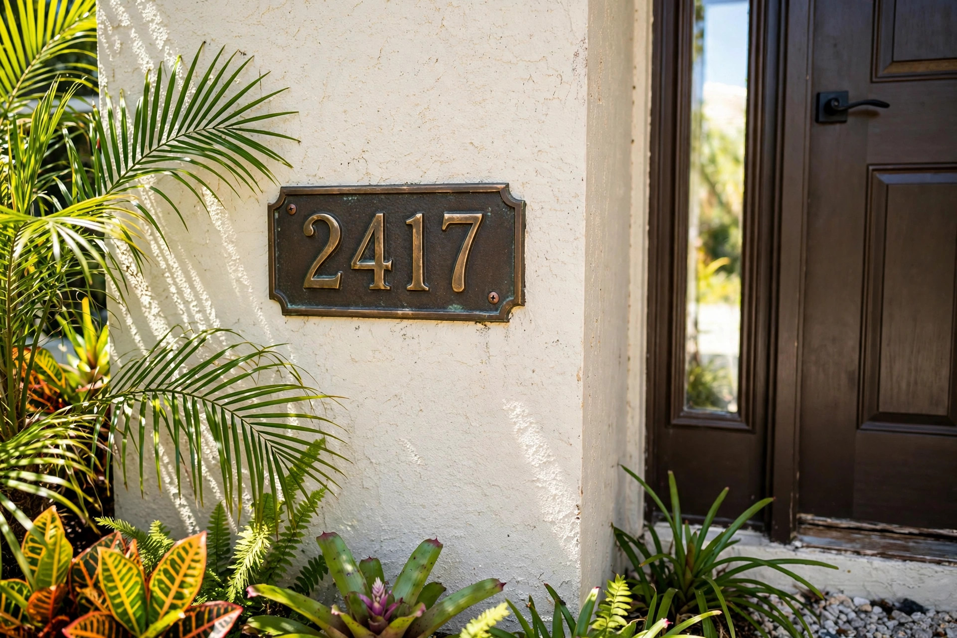 top rated house number plaques for florida homes: Bronze house number plaque mounted beside the front door of a Florida home
