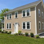 Freshly painted wood siding on an American house showing exterior wood siding painting cost usa