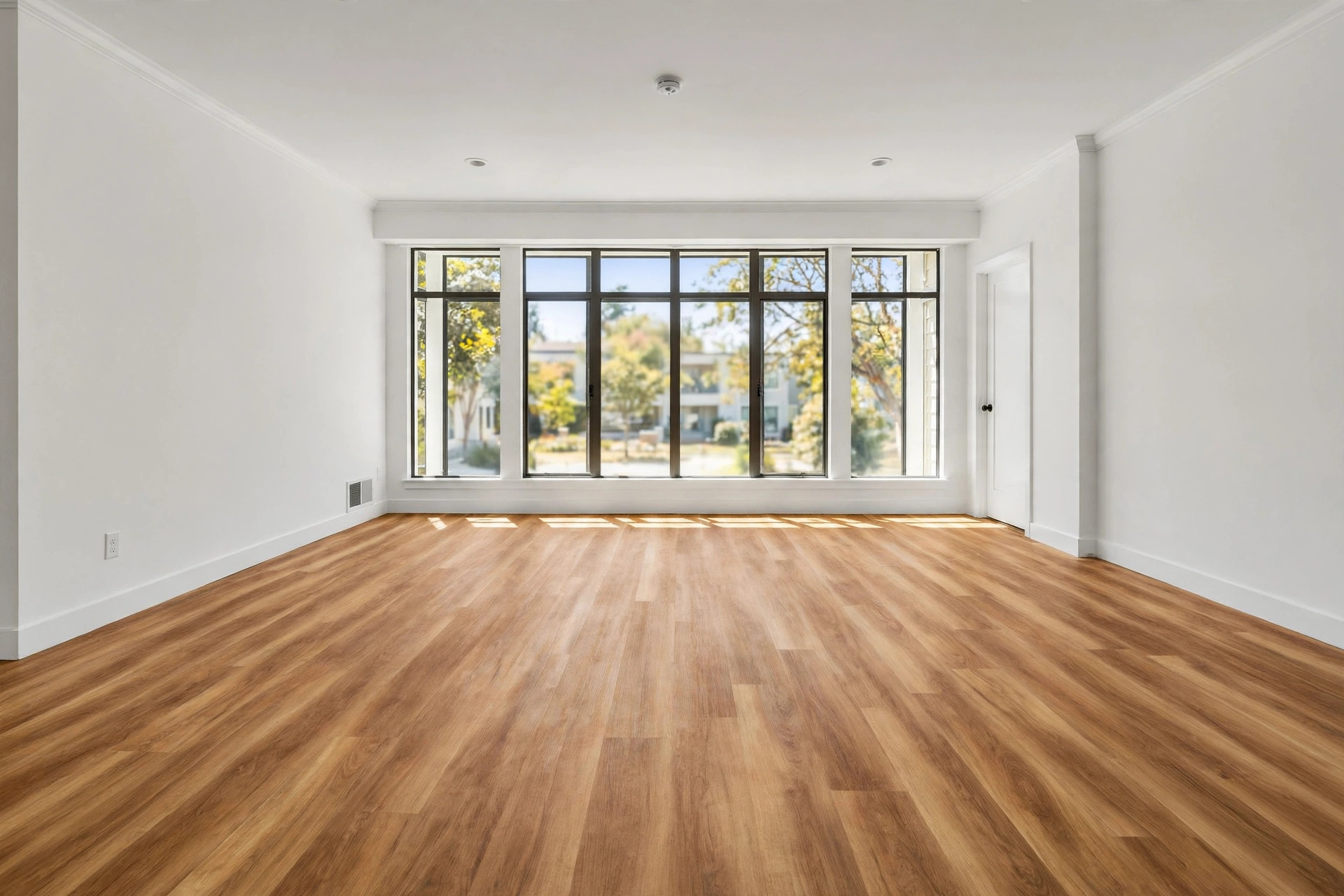 durable flooring for rental properties usa: A new vinyl plank floor in an empty American rental living room