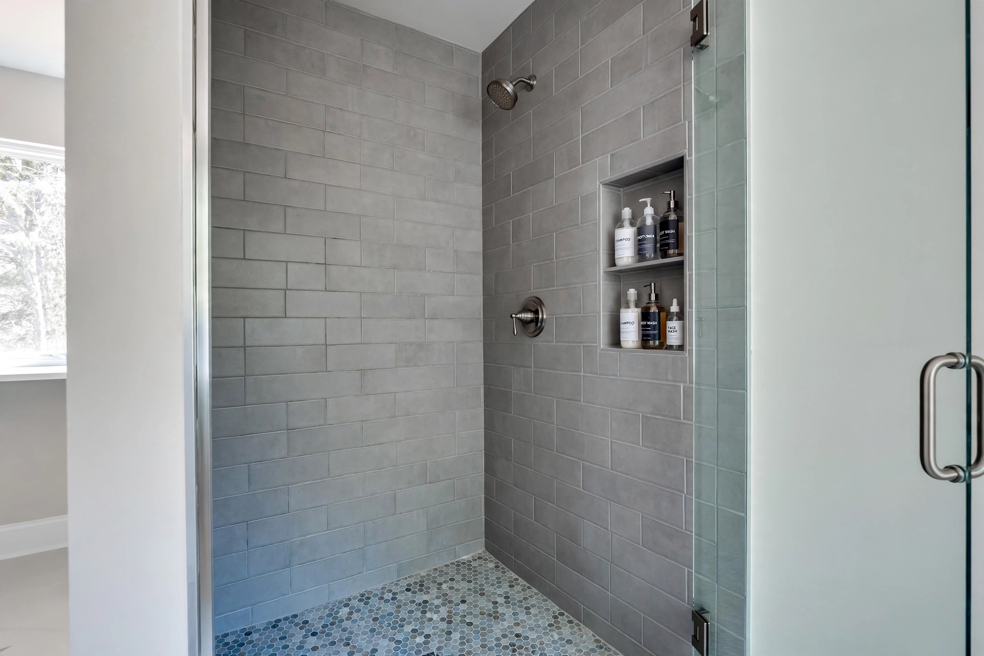 shower remodel cost breakdown for usa homes: Newly remodeled walk-in shower with tile walls and glass door