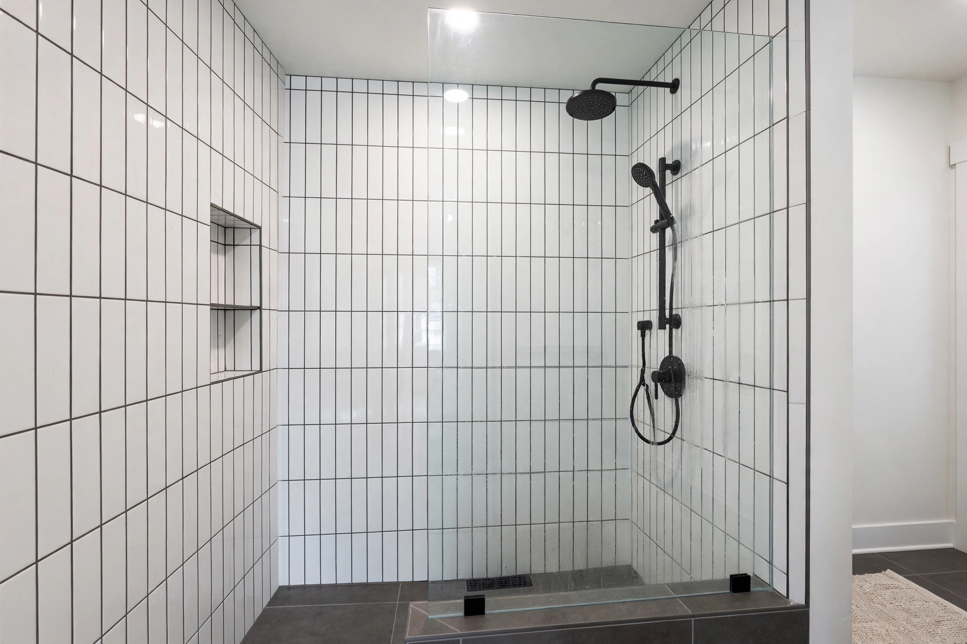 Vertical subway tile shower ideas usa: glossy white vertical subway tile in a walk-in shower