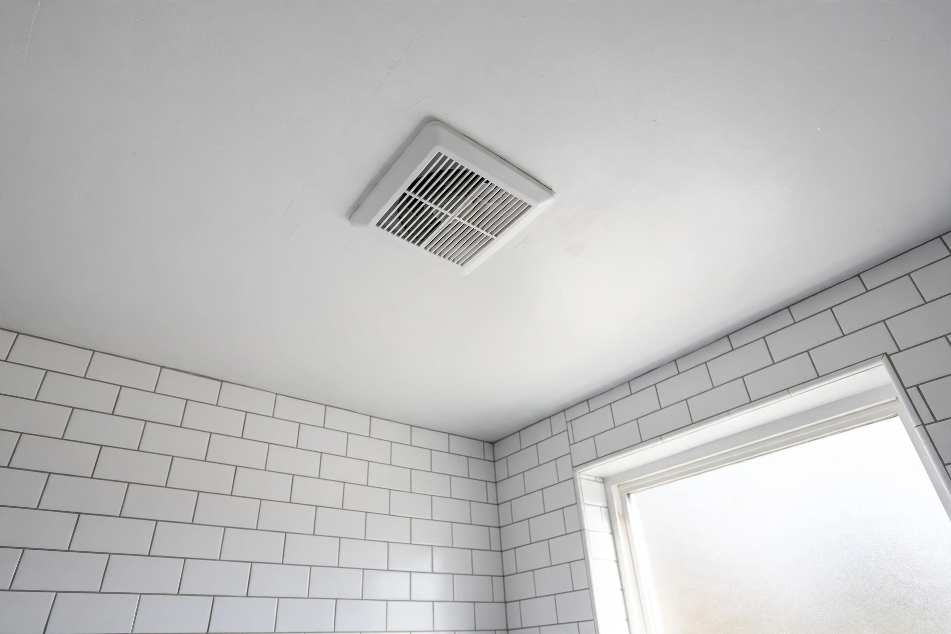 quiet exhaust fans deals near me: Quiet bathroom exhaust fan installed in a modern American bathroom ceiling