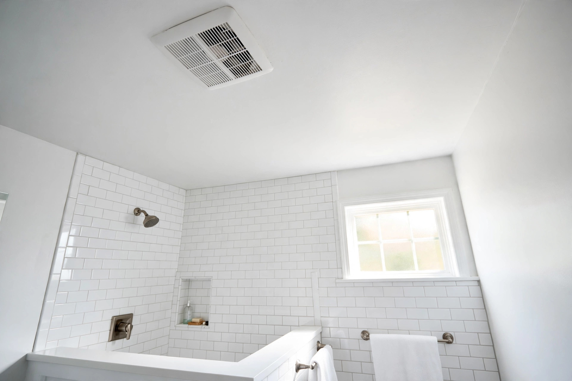 quiet exhaust fans reviews buying guide usa: Quiet exhaust fan mounted in a white bathroom ceiling