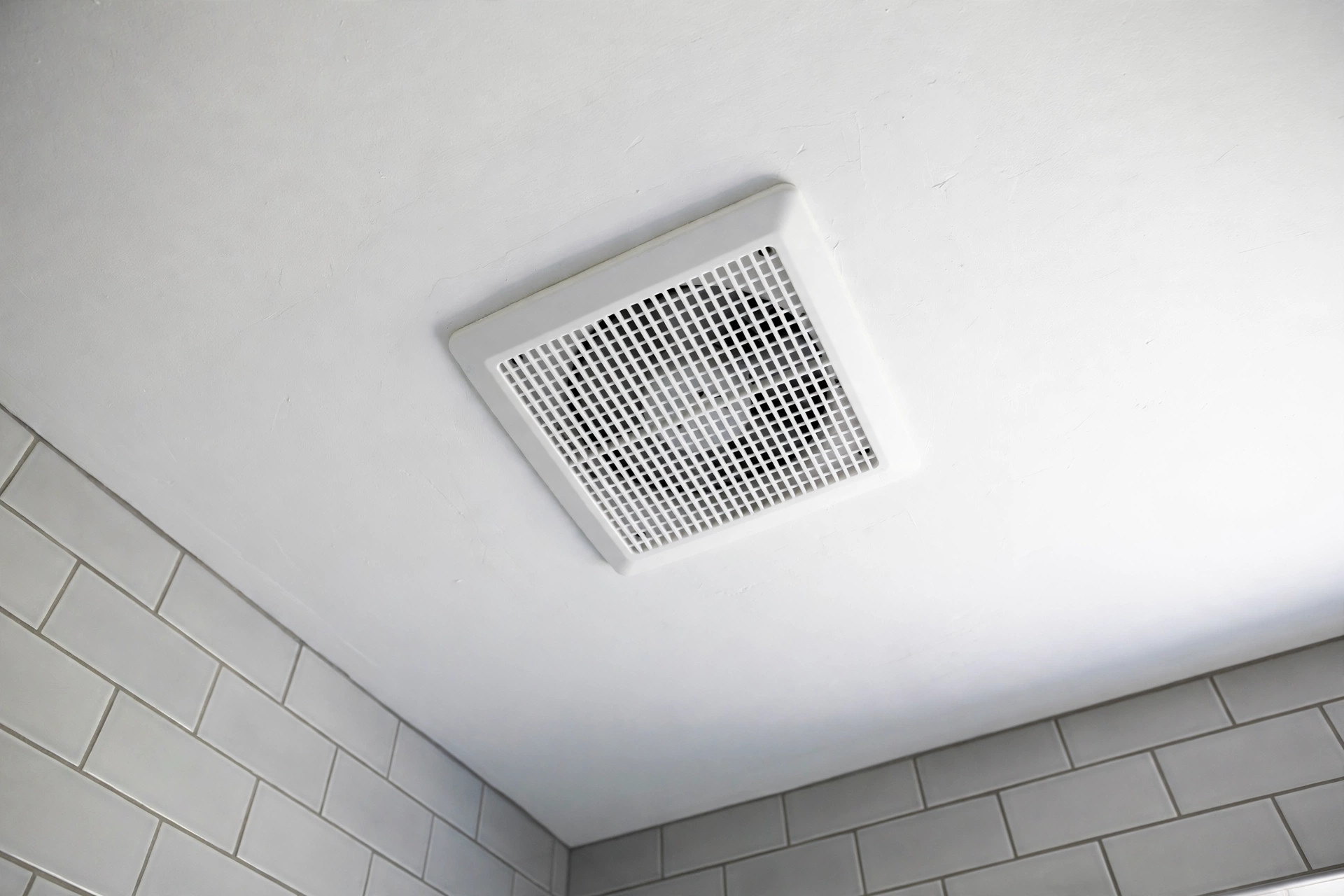 quiet exhaust fans california homes usa: Quiet exhaust fan grille on a bathroom ceiling in a California home