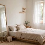 bright small bedroom with light colors and mirror